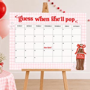 Może przedstawiać: Różowo-biały kalendarz w kratkę z czerwonym napisem "guess when she'll pop". Po prawej stronie znajduje się ilustracja butelki Coca-Coli. Balony i stół z butelką Coca-Coli i kwiatami znajdują się na pierwszym planie.