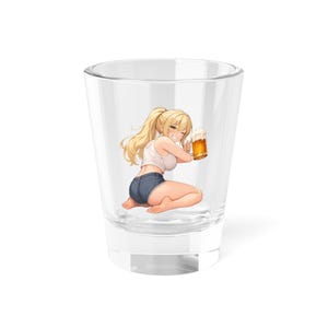 May include: Clear shot glass featuring a cartoon illustration of a blonde woman holding a mug of beer. The woman is wearing a white tank top and denim shorts. The glass is transparent, and the background is white.