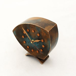 Brown wooden standing  clock with gold turquoise accents, The clock face features gold dots on round and two gold hands for hours and minutes  face