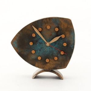 Brown wooden standing  clock with gold turquoise accents, The clock face features gold dots on round and two gold hands for hours and minutes  face