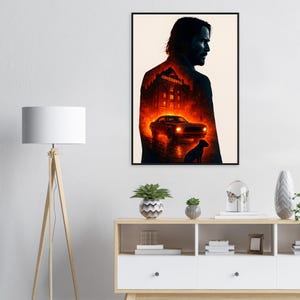 May include: A framed art print featuring a silhouette of a man with a fiery background. The image includes a car, a dog, and the word "CONTINENTAL". The artwork is predominantly black, red, and orange.