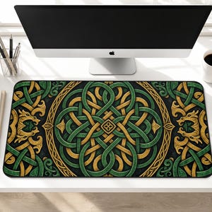 May include: A rectangular desk mat featuring an intricate Celtic knotwork pattern in shades of forest green and gold. The design includes symmetrical interlacing lines and stylized dragon motifs on a dark background, creating a detailed visual texture.