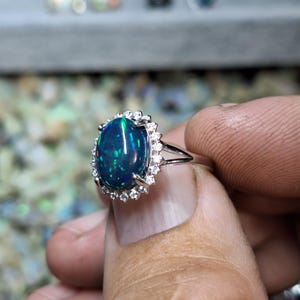 beautiful dark blue green opal in a silver diamond ring