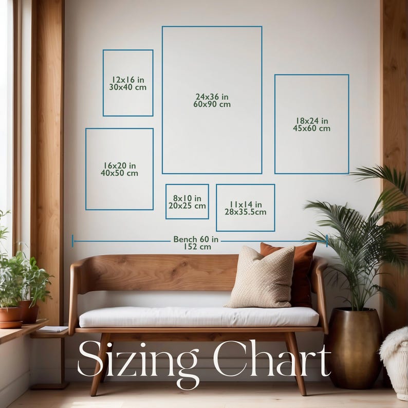 Op de afbeelding: Een maattabel met zes rechthoekige kaders op een muur boven een houten bank. De kaders zijn gelabeld met afmetingen in inches en centimeters: 12x16, 16x20, 24x36, 18x24, 8x10 en 11x14. Een meetlijn geeft aan dat de bank 152 cm breed is.