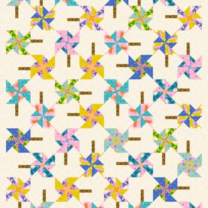 Könnte beinhalten: Ein farbenfroher Quilt mit einem sich wiederholenden Muster aus Windrädern in Blautönen, Rosa, Gelb und Grün. Die Windräder sind in einem Gittermuster auf einem weißen Hintergrund mit kleinen braunen Punkten angeordnet.