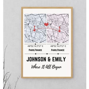 May include: Framed print featuring two map sections of Paris, France, connected by a dotted line and a heart. The print includes the coordinates 48°51' N 2°17' E and the names JOHNSON & EMILY with the text "Where It All Began".