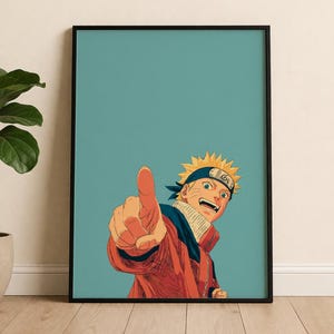 May include: Framed print featuring a vibrant illustration of an anime character with spiky yellow hair, a blue headband, and an orange jacket. The character is pointing with a determined expression against a teal background.
