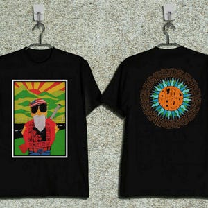 Könnte beinhalten: Schwarzes T-Shirt mit einem farbenfrohen Grafikdesign eines Mannes mit Sonnenbrille und Bart, der eine Zigarette hält. Auf der Rückseite des Shirts befindet sich ein kreisförmiges Design mit dem Schriftzug "Blind Melon".