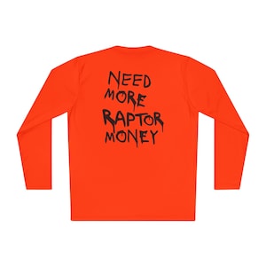 May include: Vibrant orange long-sleeved shirt featuring the phrase "NEED MORE RAPTOR MONEY" in black, dripping-style font. The shirt has a round neck and a comfortable fit. The text is positioned on the back of the garment.