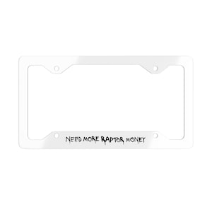 May include: A white license plate frame with the text "NEED MORE RAPTOR MONEY" in black, centered at the bottom. The frame has a rectangular shape with rounded corners and four mounting holes.
