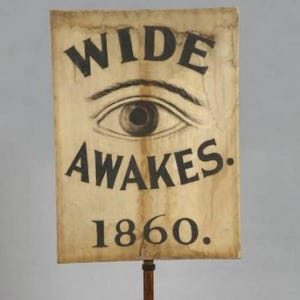 a sign with the text "WIDE AWAKES 1860" and an eye illustration.