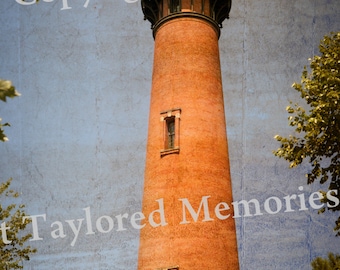 May include: A tall, brick lighthouse with a dark top and windows, set against a blue sky. The lighthouse is a reddish-orange color and surrounded by green trees. The text "Copyright Taylored Memories" is visible.