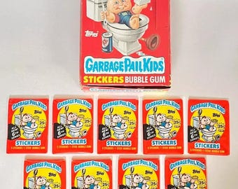 May include: A collection of eight Garbage Pail Kids sticker packs. Each pack features a red background with a cartoon character and the text "Garbage Pail Kids" and "Stickers Bubble Gum". The packs are all from the 6th series.