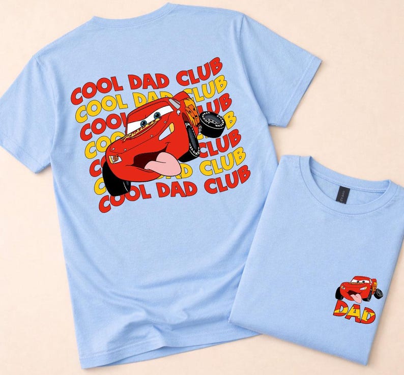 May include: Two light blue t-shirts. One features a large graphic of a red race car with the text "COOL DAD CLUB" in yellow and red. The other shirt has a smaller car graphic with the word "DAD".