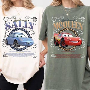 Puede incluir: Dos camisetas, una crema y otra verde oliva, con gr&aacute;ficos de coches de dibujos animados. La camiseta crema muestra "Lightning's Sally" con un coche azul, mientras que la camiseta verde muestra "Lightning McQueen" con un coche rojo. Ambas camisetas tienen marcos decorativos y texto.