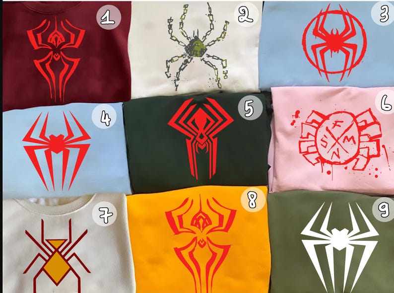 May include: A collection of nine sweatshirts, each featuring a unique spider-themed graphic in various colors. Designs include stylized spider emblems and web patterns in red, white, and yellow on maroon, white, blue, pink, green, and yellow backgrounds.