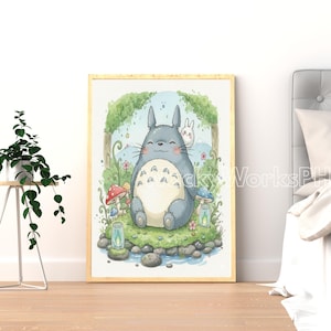 May include: A framed watercolor print featuring a smiling, gray, cartoon-like character with a white belly, sitting in a grassy area with mushrooms and a small stream. A white rabbit is peeking from behind. The artwork has a light wood frame.