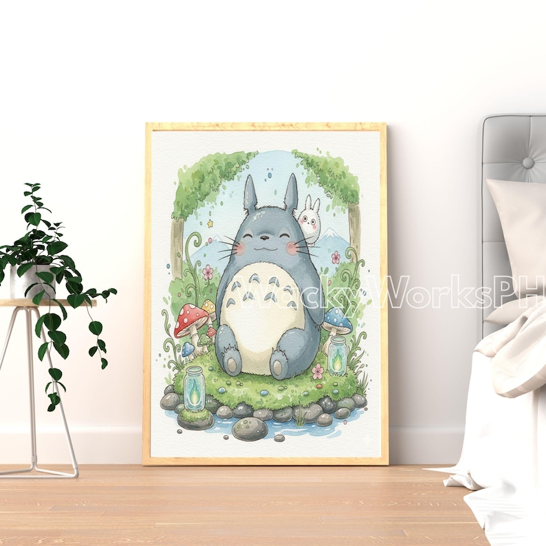 May include: A framed watercolor print featuring a smiling, gray, cartoon-like character with a white belly, sitting in a grassy area with mushrooms and a small stream. A white rabbit is peeking from behind. The artwork has a light wood frame.