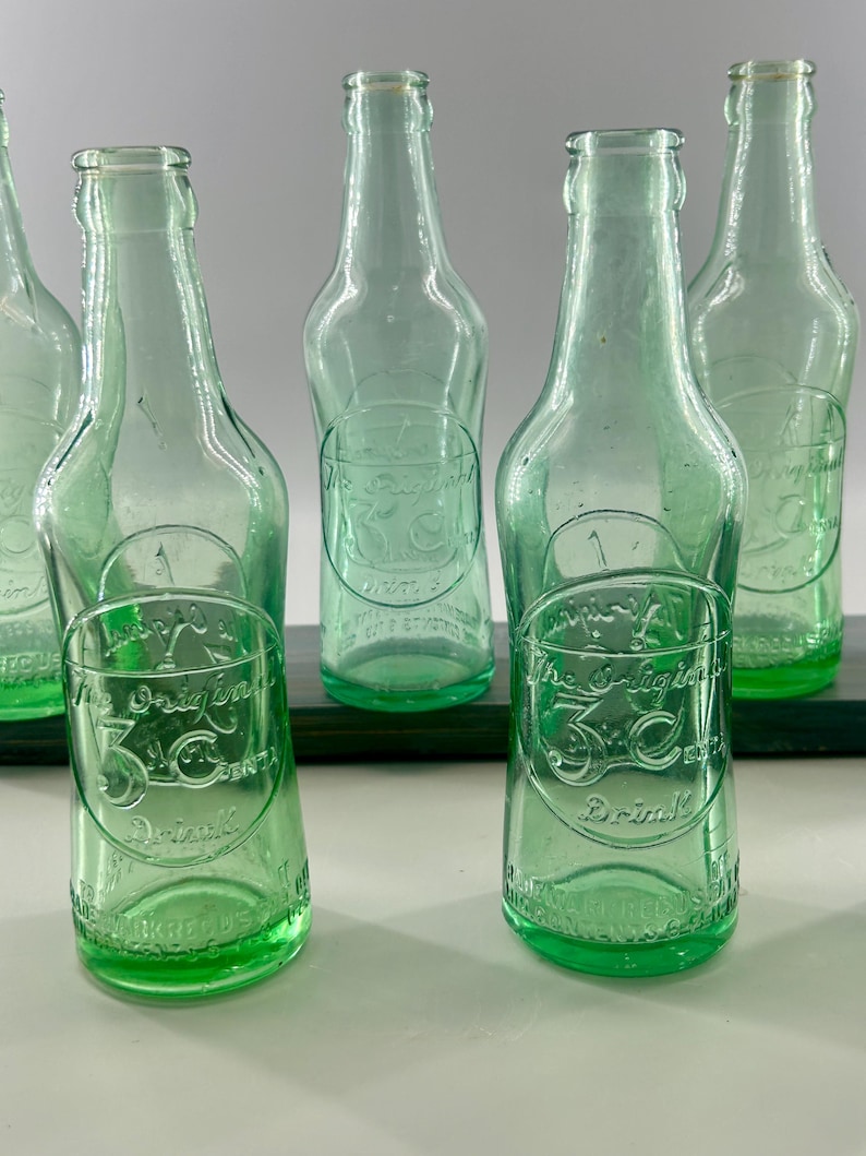 Two aqua 3 Centa bottles shown front-facing with additional bottles behind them.