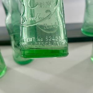 Close-up of the lower front and heel showing embossed maker information and base texture.