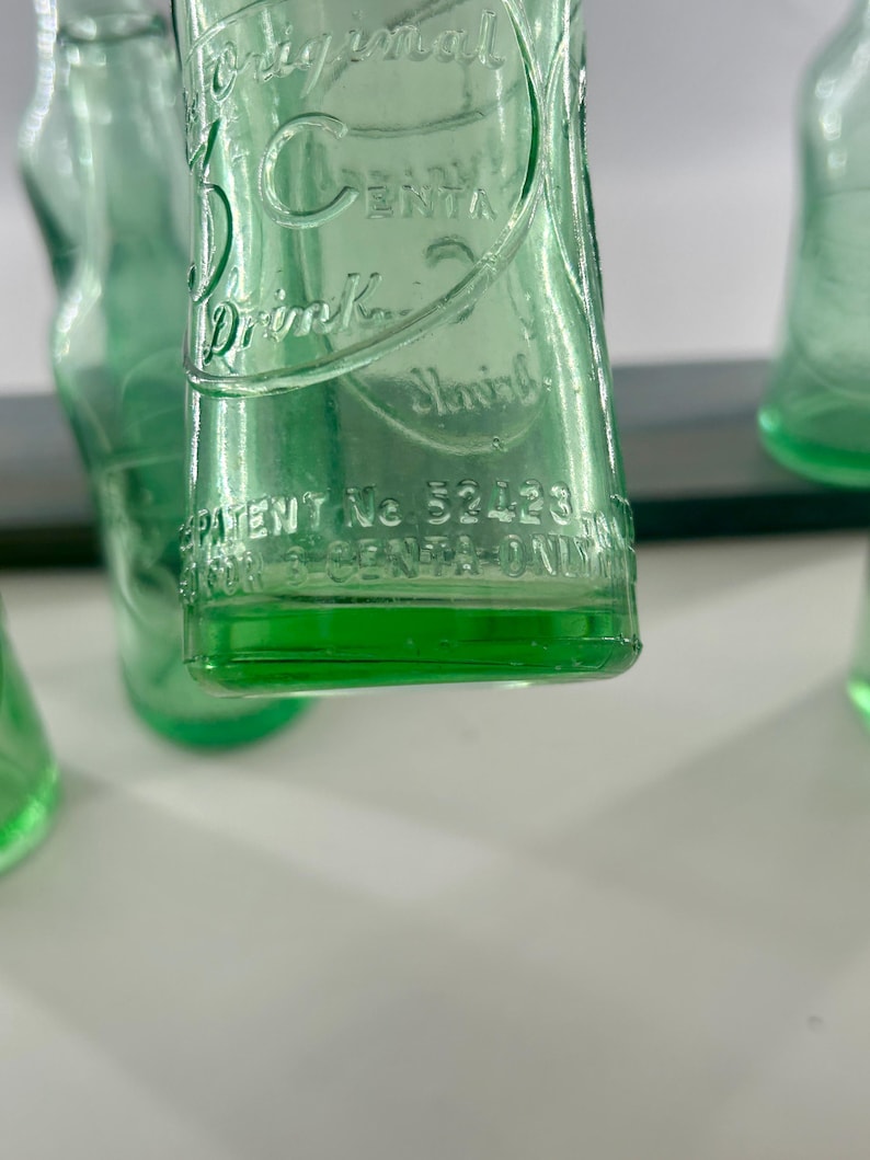Close-up of the lower front and heel showing embossed maker information and base texture.