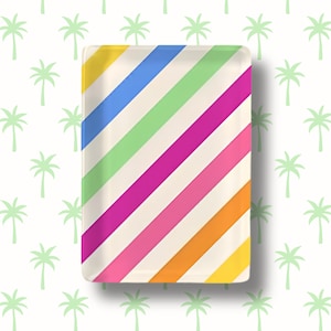 May include: A rectangular glass tray featuring a vibrant pattern of diagonal stripes in shades of blue, light green, magenta, pink, orange, and yellow against a cream-colored background, with rounded corners and a smooth, glossy finish.