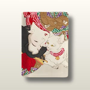 May include: A rectangular ceramic tray featuring a stylised illustration of a person with dark hair and a red headpiece resting next to a white cat wearing a red collar with a gold bell. The background includes brown and green geometric patterns.