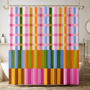 May include: A colorful shower curtain with a plaid design. The top section features a grid pattern of pink, green, yellow, and blue stripes on a white background. The bottom section has vertical stripes in various colors, including blue, green, orange, and pink.