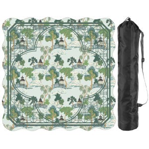 May include: A square picnic blanket with scalloped edges featuring a repeating pattern of pagodas, bridges, and trees in shades of green and blue on a light background, accompanied by a black cylindrical carrying bag with an adjustable strap.