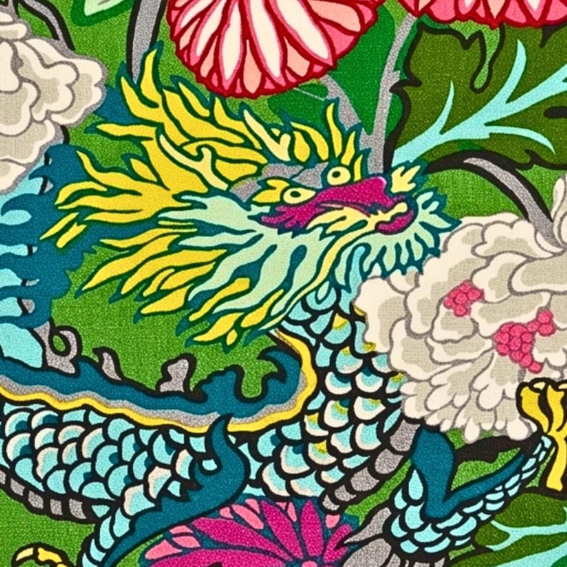 May include: A vibrant, detailed illustration of a dragon amidst floral elements. The dragon features a teal body, yellow mane, and pink accents, set against a green backdrop with white and pink flowers. The design has a bold, colorful aesthetic.