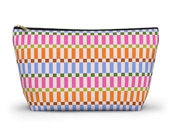 May include: A rectangular cosmetic bag with a vibrant geometric pattern. The design includes vertical stripes in pink, orange, green, blue, and brown, set against a light beige backdrop. It has a black zip and a gold-coloured zip pull.