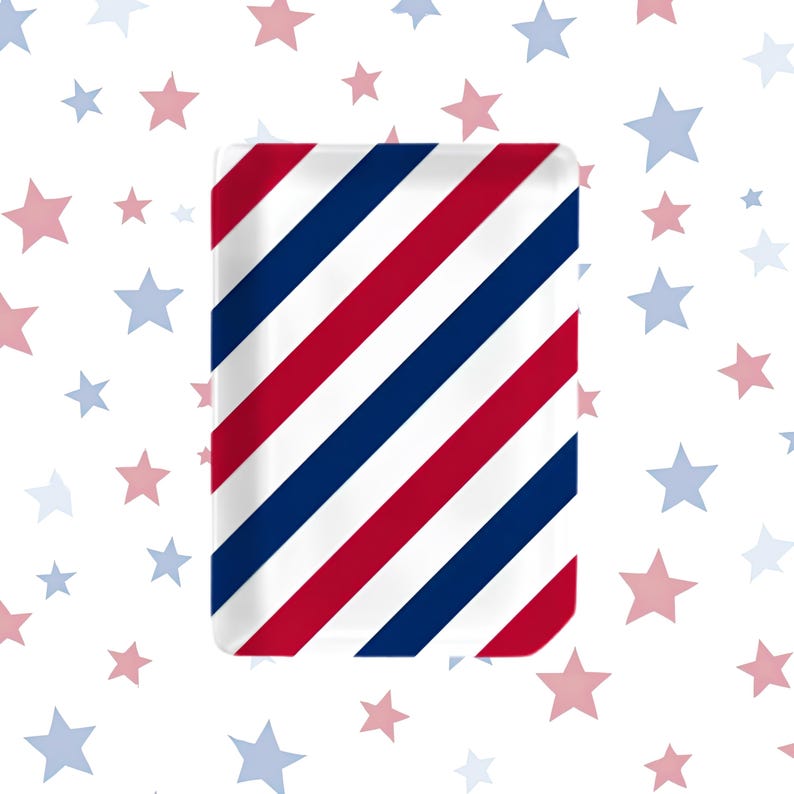 May include: A rectangular tray featuring a repeating diagonal pattern of bold red, white, and navy blue stripes. The surface is smooth and glossy, displaying a clean, geometric design that spans the entire face of the rectangular object.