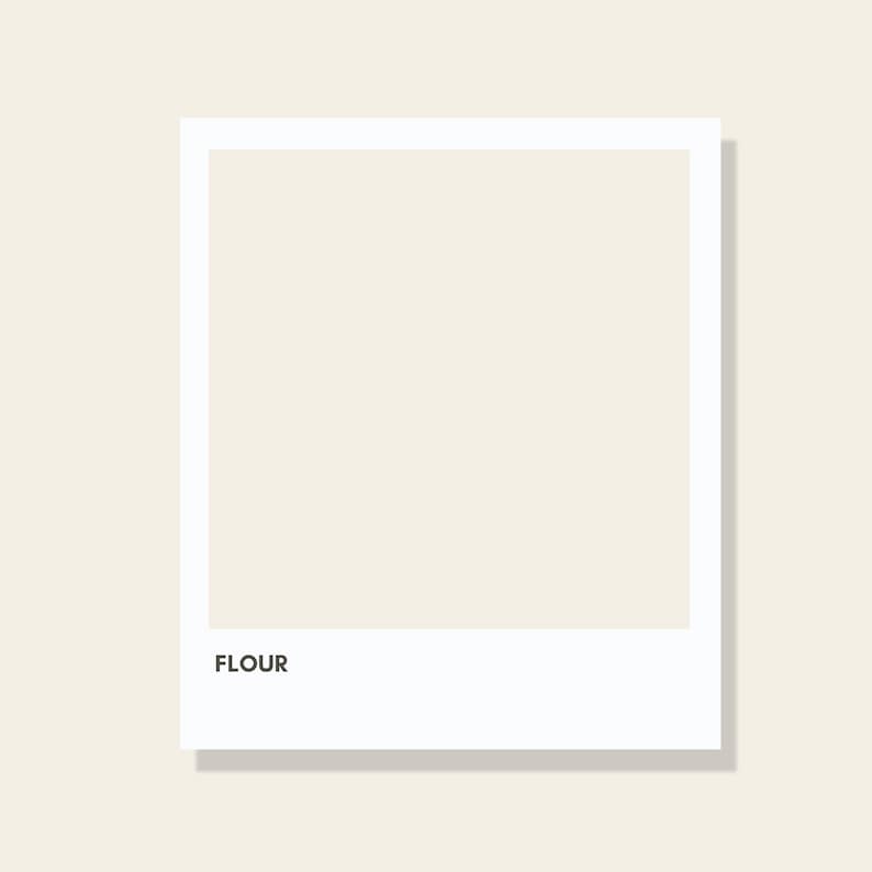 May include: A square graphic print featuring a solid off-white or cream-colored center panel framed by a thick white border. The word FLOUR is printed in a simple, bold, black sans-serif font in the lower-left corner of the white border area.