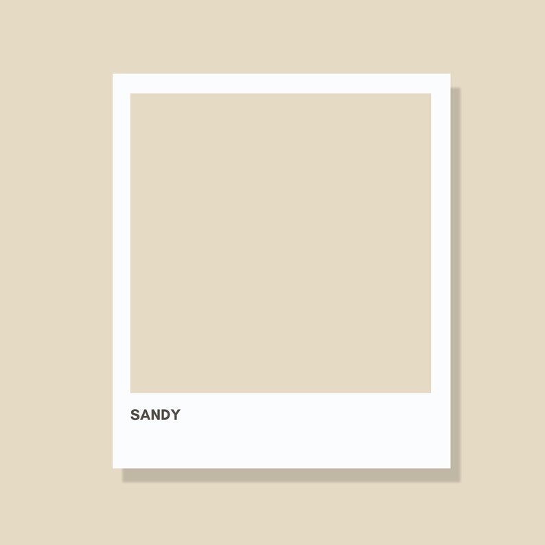 May include: A square graphic print featuring a solid sandy beige color block framed by a thick white border. The word SANDY is printed in a clean, black sans-serif font in the lower left corner of the white border area, creating a simple design.