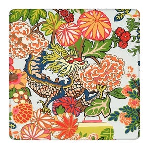 May include: A square textile featuring a repeating pattern of a central dragon with yellow, blue, and white scales surrounded by large, vibrant orange, pink, and red chrysanthemum flowers and green foliage on a light off-white background.