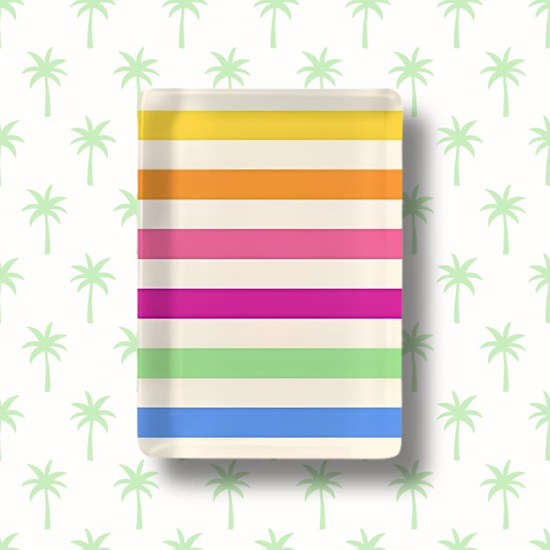 May include: A rectangular tray featuring a series of horizontal stripes in yellow, orange, pink, magenta, light green, and blue, separated by thin cream-colored bands. The tray has a smooth, glossy finish and rounded corners, presenting a clean design.