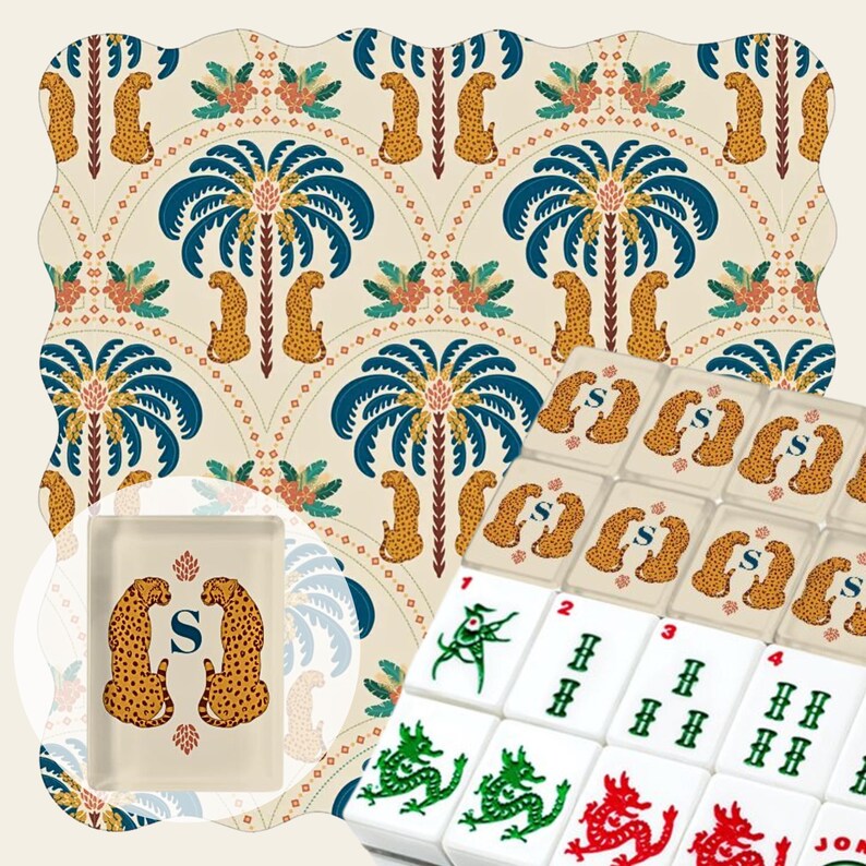 May include: A mahjong set featuring white tiles with green and red dragon symbols, alongside a rectangular tray and a patterned fabric background. The tray and fabric display a repeating design of yellow leopards and blue palm trees with the letter S.