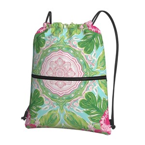 May include: Drawstring backpack with a vibrant floral design. The pattern includes a central pink and white floral medallion, green leaves, and pink flowers set against a light blue backdrop. It has black drawstrings and a black zip.