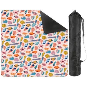 May include: A patterned beach blanket featuring seashells in orange, blue, yellow, and pink. The blanket has a black underside and is accompanied by a black carry bag with a shoulder strap. The blanket is ideal for outdoor use.