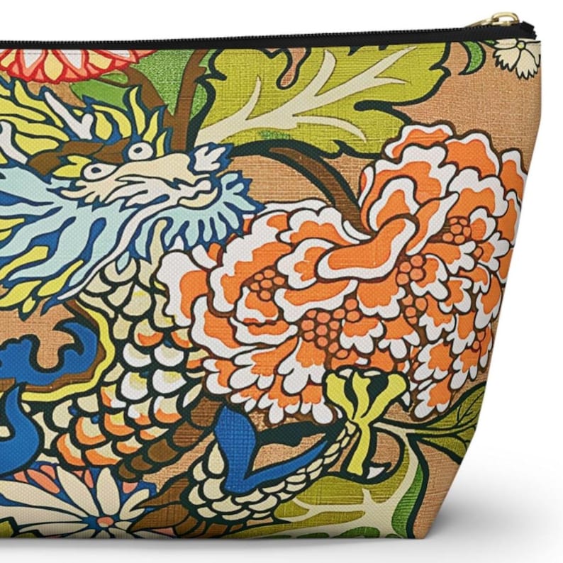 May include: A zipped pouch featuring a vibrant, multi-coloured print on a tan background. The design displays a stylised dragon with blue and white scales, surrounded by large orange and white peony flowers and bright green foliage.