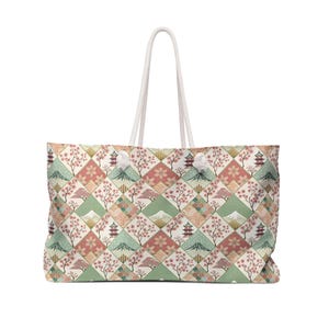 May include: Large tote bag with a Japanese-inspired design. The pattern includes cherry blossoms, pagodas, and mountains in pink, green, and cream. It has white rope handles. The bag is ideal for carrying items.