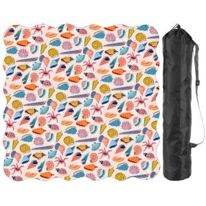 May include: A beach blanket featuring a pattern of colourful seashells and starfish on a pale pink background. The blanket has a wavy edge and is accompanied by a black carry bag with a shoulder strap.