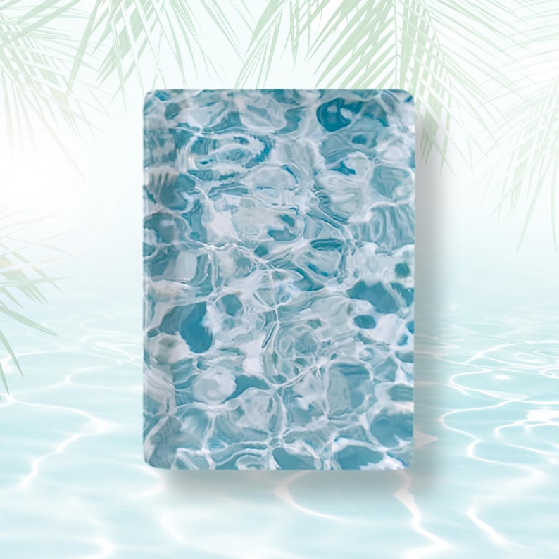 May include: A rectangular tray featuring a vibrant, high-contrast pattern of shimmering blue and white water ripples. The surface displays a glossy finish with intricate, swirling light reflections that mimic the appearance of a sunlit swimming pool.