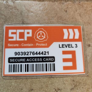 May include: Orange and white SCP Level 3 Secure Access Card. The card features the SCP logo, the text "Secure - Contain - Protect", a 12-digit number, a barcode, and the words "SECURE ACCESS CARD".