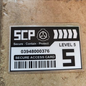 May include: A rectangular, black and white access card with the text "SCP" and the words "Secure - Contain - Protect." The card also displays the number "03948000376," the words "SECURE ACCESS CARD," and a barcode.