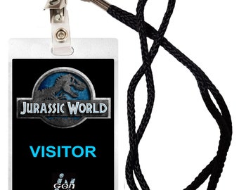May include: A black and white plastic ID card with a Jurassic World logo, the text "VISITOR" and a barcode. The card is attached to a black lanyard with a silver clip.