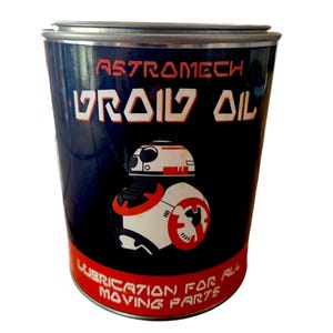 May include: A cylindrical metal container with a black background and the words "ASTROMECH DROID OIL" in white and red. The container features a graphic of a droid and the text "LUBRICATION FOR ALL MOVING PARTS".
