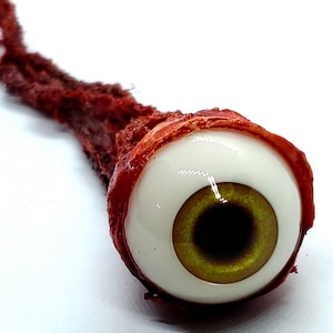 Accesorio de Halloween: horror realista de tamaño real arrancado globo ocular conejo amarillo