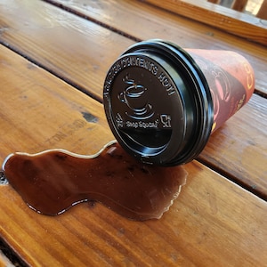 Realistic fake coffee cup spill with lid by Dead Head Props, Great as as a gag gift or prank!