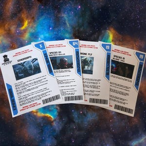 May include: Five white cards with blue borders, each detailing an alien species, set against a nebula backdrop. The cards, branded with the Prodigy Corp logo, showcase images and information on species like Xenomorph and Drone Fly. Measurements are not applicable.